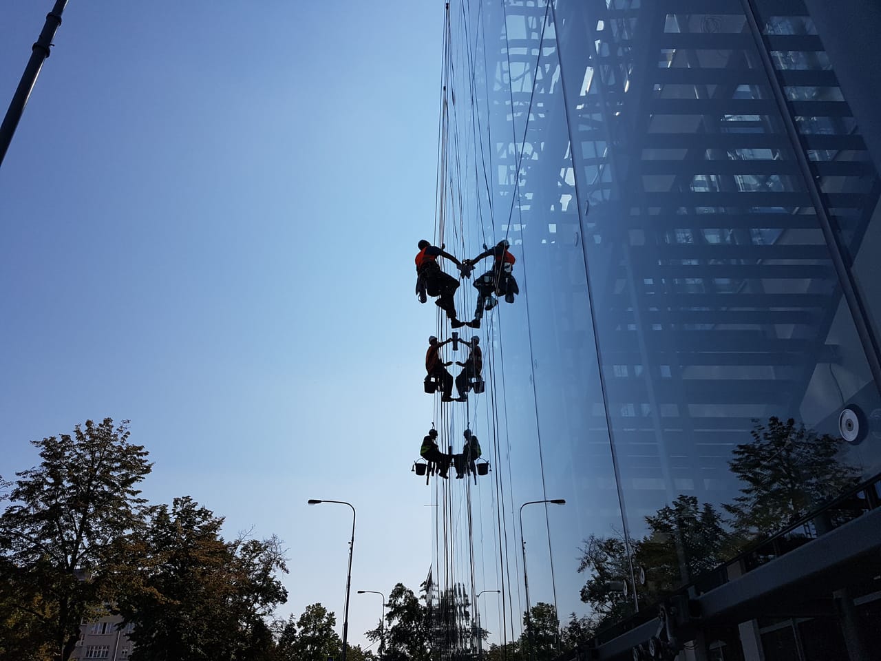 Washing the glass facade on a rope