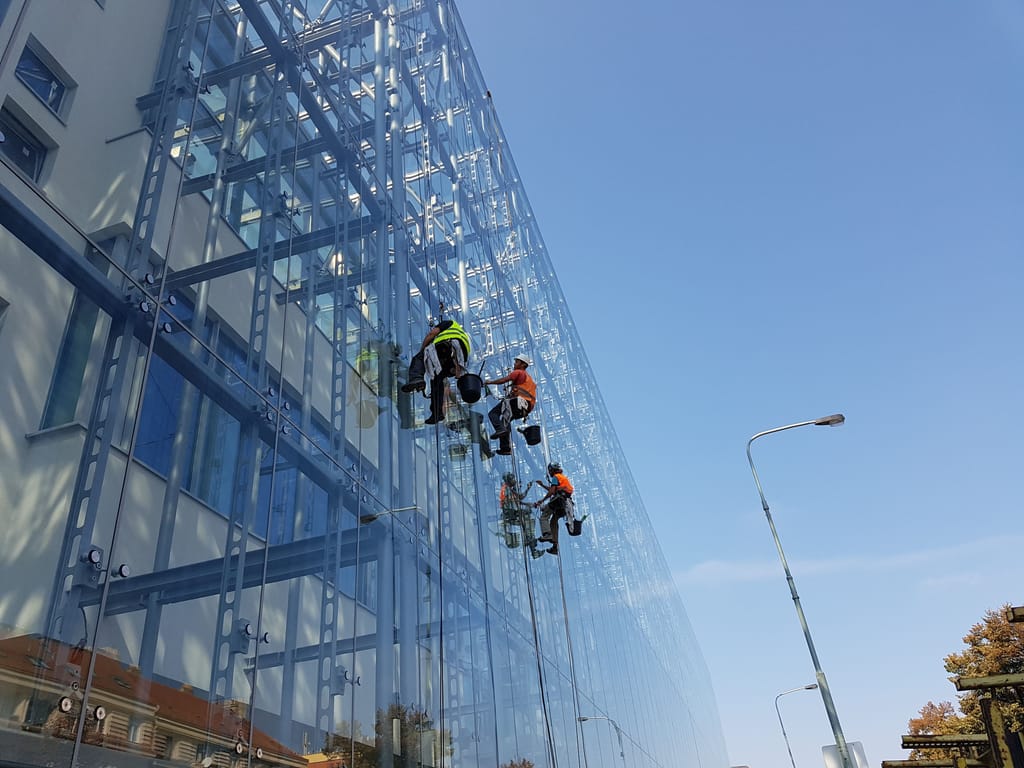 Washing the glass facade on a rope